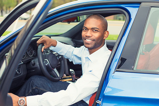 man sitting in car
