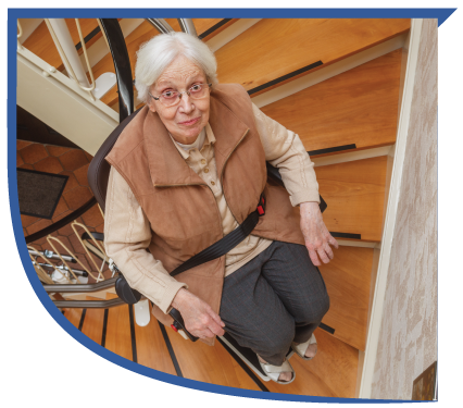 Elderly lady safely riding a stair elevator.